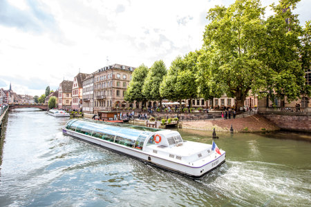 STRASBOURG, FRANCE - July 26, 2017: Landscape view on the water channel with tourist boat and beautiful half-timbered houses in Strasbourg city in Alsace region, Franceのeditorial素材