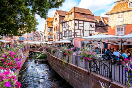 COLMAR, FRANCE - July 26, 2017: Landscape view on the beautiful colorful buildings on the water channel with bars and restaurants in the famous tourist town Colmar in Alsace region, Franceのeditorial素材