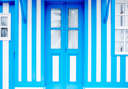 Facade view on the beautiful colorful striped house with windows and door for backgroundの写真素材
