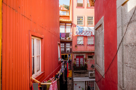 View on the narrow street with ancient buildings in Porto city, Portugalの写真素材