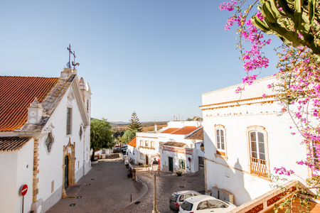 Typical village with white old church during the sunrise on the south of Portugalの写真素材