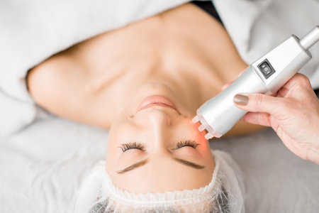 Young woman during a facial massage with professional tool at the medical center