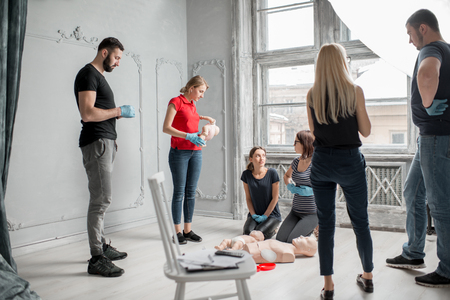People having a conversation during the first aid group training indoorsの写真素材