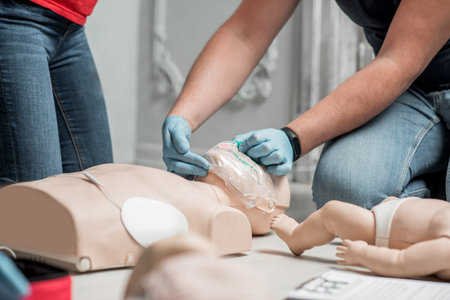 Showing how to throw back dummies head for breathing during the first aid group training indoorsの写真素材