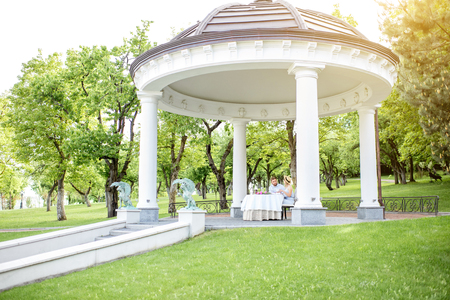 View on the beautiful royal alcove with couple having romantic breakfast in the gardenの写真素材