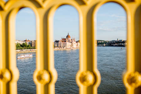 Landscape view through the fencing on the famous parliament building during the sunset in Budapest city, Hungaryの写真素材
