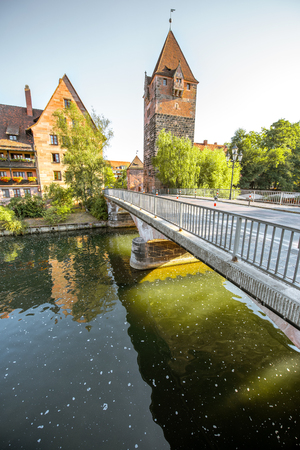 Morning view on the riverside with beautiful old tower and bridge in Nurnberg city, Germanyの写真素材