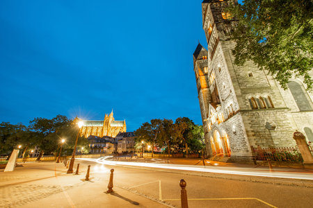 Night view on the illuminated street with Neuf basilica and cathedral on the background in Metz city in Lorraine region of Franceの写真素材
