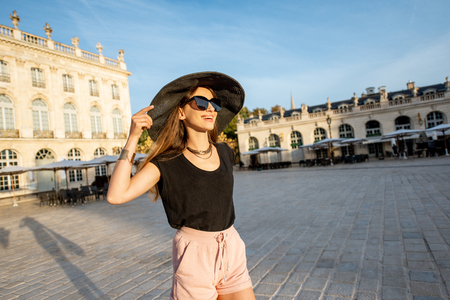 Young woman tourist having fun on the central square traveling in Nancy city in Franceの写真素材