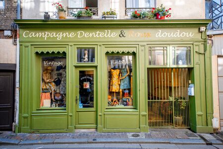 HONFLEUR, FRANCE - September 06, 2017: Street view with beautiful store front with clothes in Honfleur old town, normandy region in France