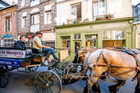 HONFLEUR, FRANCE - September 06, 2017: Horses ride a carriage with tourists on the street in the old town of Honfleurのeditorial素材
