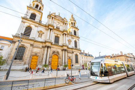 NANCY, FRANCE - September 10, 2017: Street view with Notre-Dame cathedral and modern tram during the...