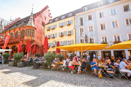 FREIBURG, GERMANY - September 10, 2017: Market square with restaurants and bars crowded with...