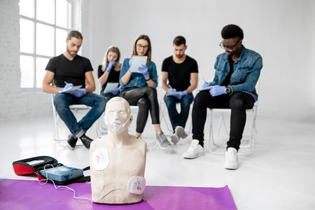 Medical stuff for first aid training with group of young people on the backgroundの写真素材