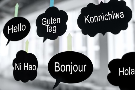 Black stickers in form of clouds with greeting words on the glass wall in the officeの写真素材