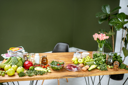 Nutritionists working place with variety of healthy raw food on the table in the green officeの写真素材