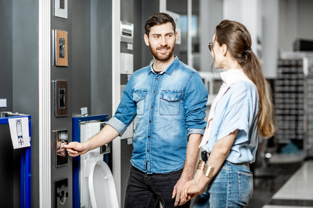 Young couple choosing buttons for drain of a new ceramic bowl in the plumbing shopの写真素材