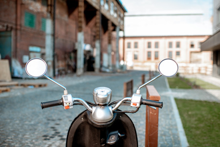 Helm of a retro motorbike parked outdoors on the urban streetの写真素材