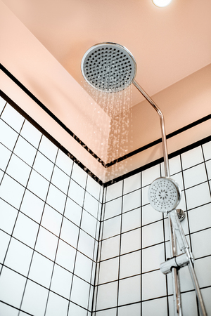 Shower with falling drops of water in the bathroomの写真素材