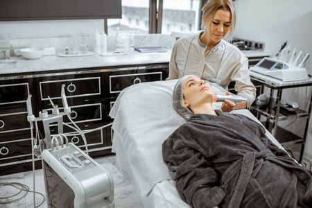 Female cosmetologist making oxygen mesotherapy to a woman at the luxury beauty salon. Concept of a...