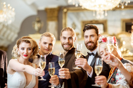 Portrait of a group of elegant people well-dressed in retro styles hanging out together, having fun...