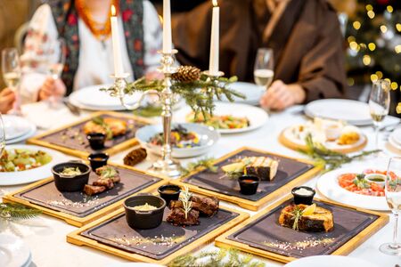 Beautifully decorated table with expensive and delicious dishes on a New Year's Eveの写真素材