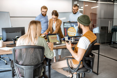 Group of diverse creative people working as a web designers in the modern office, young couple...