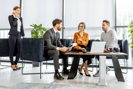 Young couple having an important discussion with financial consultant at the luxury bank office. Investment or lending concept for a young familyの写真素材