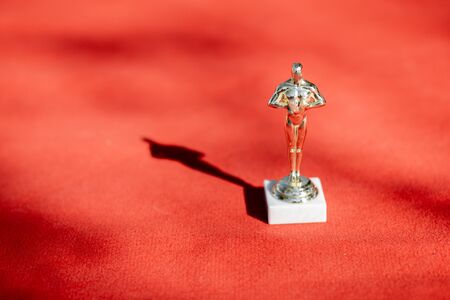 Famous film award statue on the red carpet outdoors, close-upの写真素材