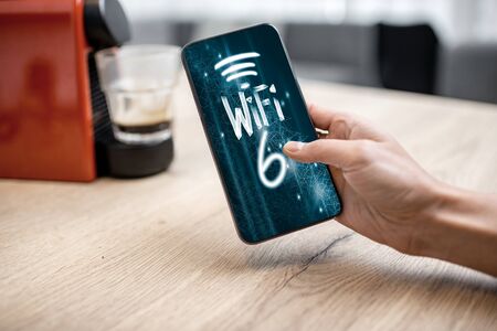 Using smart phone with high speed network connection at home, close-up viewの写真素材