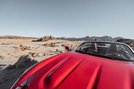 Convertible car on the roadside of the desert valley, traveling by car conceptの写真素材