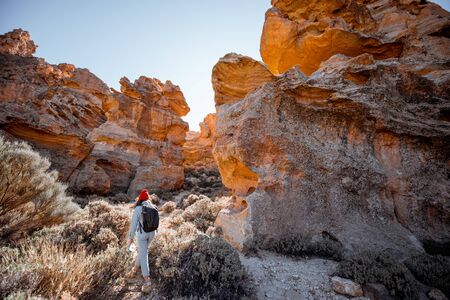 Landscape of a beautiful rocks on the desert valley with woman traveling at the natural park near Teide volcano on Tenerife island, Spainの写真素材