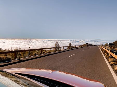 Beautiful straight road above the clouds on Tenerife island, Spain. Image made on mobile phoneの写真素材