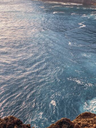 Top view on the steep precipice on rocky coast. Image made on mobile phoneの写真素材