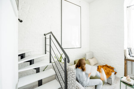 Interior view of the bright modern living room with a blurred in motion human figure