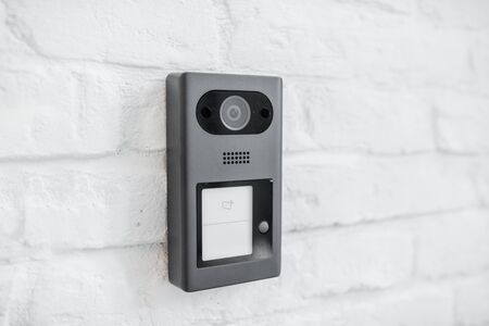 House intercom with a camera on the brick wall outdooorsの写真素材