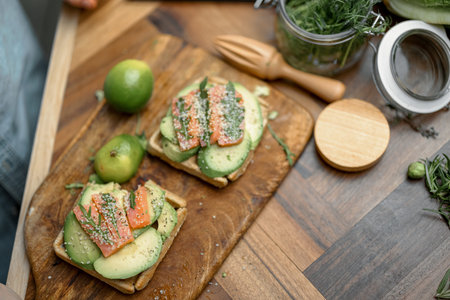 Served avocado toasts on the kitchen board