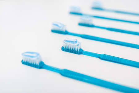 Plastic blue toothbrushes with toothpaste isolated on a white backgroundの写真素材