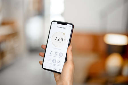 Smartphone with launched application for temperature adjustmentの写真素材