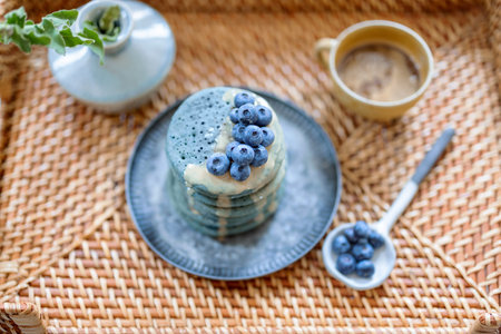 Rattan tray with blue american pancakes with blueberry.