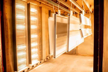 Painter in protective wear paints metal products with powder paint. Powder coating process at the manufacturing. High quality photoの写真素材