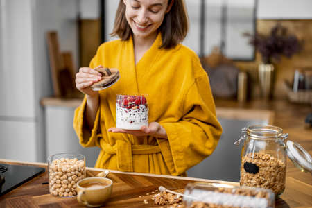 Woman eating healthy cereal breakfastの写真素材