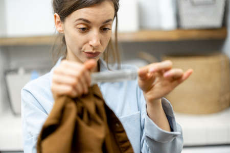Woman washing clothes at homeの写真素材
