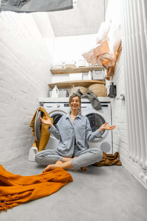 Housewife throwing up clothes at the laundryの写真素材