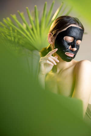Portrait of a woman in black cleansing maskの写真素材