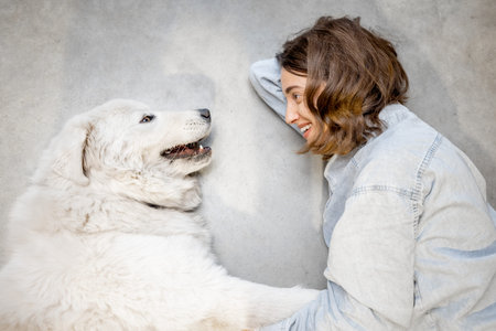 Woman with her dog lying together