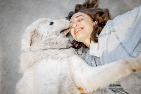 Woman with her dog lying togetherの写真素材