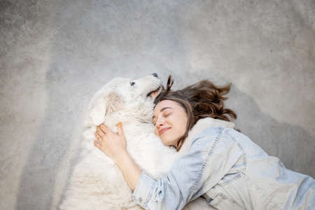 Woman with her dog lying togetherの写真素材
