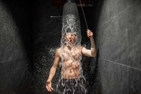 Man hardening with bucket of ice cold water after hot sauna