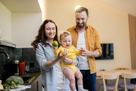 Young happy caucasian family with a little boy on the kitchen at homeの写真素材